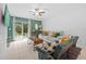 Comfortable living room with stylish furniture, neutral colors, and a sliding glass door to the patio, perfect for relaxing at 5554 Blue Azure Dr, Wimauma, FL 33598