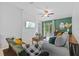 Living room featuring a TV and sliding glass doors to the backyard, providing ample natural light at 5554 Blue Azure Dr, Wimauma, FL 33598