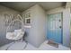 Inviting front porch with a cozy hanging chair and stylish decor at 5554 Blue Azure Dr, Wimauma, FL 33598