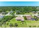 Beautiful aerial view of a single-story home with a spacious yard in a lush, green neighborhood near a pond at 5616 90Th Avenue E Cir, Parrish, FL 34219