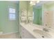 This bathroom features a single vanity sink, shower and window at 5616 90Th Avenue E Cir, Parrish, FL 34219