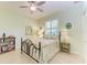 Cozy bedroom with neutral color scheme, a decorative ceiling fan, and plantation shutters at 5616 90Th Avenue E Cir, Parrish, FL 34219