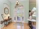 Bright foyer with stylish chandelier, decorative table, and transom window above the door at 5616 90Th Avenue E Cir, Parrish, FL 34219