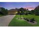 Charming home featuring a well-manicured lawn, paver driveway, and lovely landscaping at 5616 90Th Avenue E Cir, Parrish, FL 34219