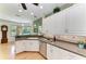 Kitchen with white cabinets, stainless dishwasher and sink overlooking backyard at 5616 90Th Avenue E Cir, Parrish, FL 34219