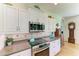 Close up view of a kitchen featuring white cabinets, tile backsplash, and stainless steel appliances at 5616 90Th Avenue E Cir, Parrish, FL 34219