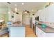 Bright kitchen with white cabinets, stainless steel appliances, and a breakfast bar overlooking the living area at 5616 90Th Avenue E Cir, Parrish, FL 34219