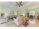 Inviting living room with hardwood floors, a ceiling fan, and comfortable seating at 5616 90Th Avenue E Cir, Parrish, FL 34219