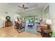 Spacious living room with hardwood floors, a ceiling fan, and sliding glass doors to the backyard at 5616 90Th Avenue E Cir, Parrish, FL 34219