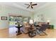Bright living room features hardwood floors, ceiling fan, and sliding doors to the patio at 5616 90Th Avenue E Cir, Parrish, FL 34219