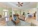 Open-concept living room with hardwood floors, seamless flow to dining area, and access to kitchen at 5616 90Th Avenue E Cir, Parrish, FL 34219