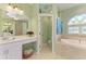 The primary bathroom features a soaking tub, separate vanity, and an open door to the water closet at 5616 90Th Avenue E Cir, Parrish, FL 34219