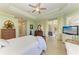 Bright main bedroom featuring light green walls, tile floors, and a sliding glass door at 5616 90Th Avenue E Cir, Parrish, FL 34219