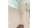Close-up of the tiled walk-in shower with a handheld shower head and convenient bench seating at 5616 90Th Avenue E Cir, Parrish, FL 34219