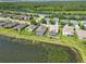 Real estate aerial view showcases community, a pool, and lake views at 5919 100Th E Ave, Parrish, FL 34219