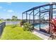 Inviting fenced in backyard with screened-in pool, lush greenery, and tranquil lake view at 5919 100Th E Ave, Parrish, FL 34219