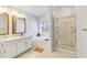Bright bathroom features a double sink vanity, soaking tub, and glass enclosed shower at 5919 100Th E Ave, Parrish, FL 34219