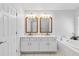 Well-lit bathroom features double sinks with large mirrors, soaking tub, and white cabinets at 5919 100Th E Ave, Parrish, FL 34219