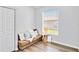 Cozy room with wood floors features window and a comfortable brown futon at 5919 100Th E Ave, Parrish, FL 34219
