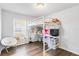 Bright bedroom featuring a loft bed with a built-in desk and chair at 5919 100Th E Ave, Parrish, FL 34219