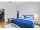 Comfortable bedroom with a cozy bed, wooden floors, and a view of the walk-in closet at 5919 100Th E Ave, Parrish, FL 34219