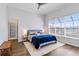 Bright bedroom with a large window, wood floors, and a comfortable bed with blue and white linens at 5919 100Th E Ave, Parrish, FL 34219