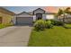 Charming single-story home with well-maintained landscaping and a gray two-car garage at 5919 100Th E Ave, Parrish, FL 34219