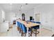 An open, eat-in kitchen featuring a long center island with room for seating, white cabinetry, and appliances at 5919 100Th E Ave, Parrish, FL 34219