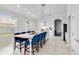 Spacious kitchen with a large island, white cabinets, stainless steel appliances, and pendant lighting at 5919 100Th E Ave, Parrish, FL 34219