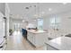 Modern eat-in kitchen featuring white cabinets and countertops with a large island and seating at 5919 100Th E Ave, Parrish, FL 34219