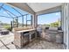 Outdoor kitchen with built-in grill, refrigerator, and stone counter, perfect for entertaining at 5919 100Th E Ave, Parrish, FL 34219