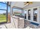 Outdoor kitchen with a stone bar, built in BBQ, and covered patio at 5919 100Th E Ave, Parrish, FL 34219