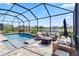 Screened-in pool featuring a seating area, overlooking a beautiful lake and neighborhood at 5919 100Th E Ave, Parrish, FL 34219