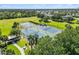 Aerial view of tennis courts in a well-maintained community with trees and pathways at 5919 100Th E Ave, Parrish, FL 34219