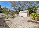 Outbuilding nestled in a tropical backyard setting with lush landscaping and a gravel area at 652 Ohio Pl, Sarasota, FL 34236