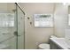 Bright bathroom featuring a glass-enclosed shower, toilet, and modern vanity sink at 652 Ohio Pl, Sarasota, FL 34236