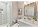 Comfortable bathroom featuring modern fixtures, decorative tile in the shower, and a framed painting of cranes at 652 Ohio Pl, Sarasota, FL 34236