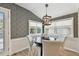 Charming breakfast nook features a stylish light fixture, three windows, and decorative wallpaper at 652 Ohio Pl, Sarasota, FL 34236