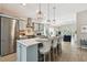 Open kitchen features stainless steel appliances, a center island with bar seating, and flows into the living room at 652 Ohio Pl, Sarasota, FL 34236
