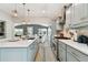 Modern kitchen featuring sleek appliances, quartz countertops, and bar seating, open to the dining and living areas at 652 Ohio Pl, Sarasota, FL 34236