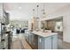 Modern kitchen with an island, bar seating, stainless steel appliances, and a view to the living room at 652 Ohio Pl, Sarasota, FL 34236
