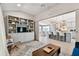 Bright living room connecting to a modern kitchen with an island and bar seating under modern fixtures at 652 Ohio Pl, Sarasota, FL 34236