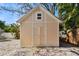 Charming outbuilding exterior with a gable roof and white trim on a brick foundation at 652 Ohio Pl, Sarasota, FL 34236