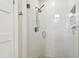 Modern walk-in shower featuring sleek white tile, glass door, and contemporary fixtures at 652 Ohio Pl, Sarasota, FL 34236