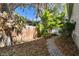 Tranquil side yard with brick pathway, mature trees, and a serene ambiance at 652 Ohio Pl, Sarasota, FL 34236