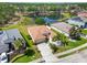 Spacious home with a manicured lawn, palm trees, and a serene pond view, captured from above at 6838 44Th E Ter, Bradenton, FL 34203