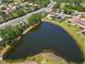 Community pond surrounded by residential homes with mature trees and natural landscaping at 6838 44Th E Ter, Bradenton, FL 34203