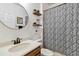 Charming bathroom with wooden shelves and a round mirror at 6838 44Th E Ter, Bradenton, FL 34203