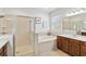 Bright bathroom features a glass-enclosed shower and a large soaking tub at 6838 44Th E Ter, Bradenton, FL 34203