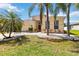 Charming home featuring mature palm trees and a landscaped yard with decorative white rocks at 6838 44Th E Ter, Bradenton, FL 34203